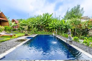 a swimming pool in a backyard with a garden at KINTAMANI Paradise Villa in Kintamani