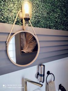 a mirror hanging above a sink in a bathroom at Stilvolle Villa mit Strandlage in Didim