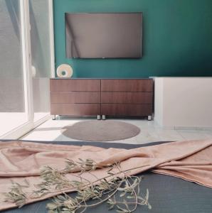 a living room with a flat screen tv on a wall at Stilvolle Villa mit Strandlage in Didim +10 photos