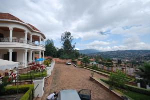 a white house with a view of a city at Step Town in Kigali