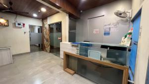 a kitchen with a glass counter in a room at U LIFE HOTEL in Mumbai