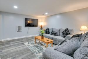a living room with two couches and a table at Convenient Hummelstown Home with Deck! in Hummelstown