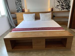a bed in a room with a wooden bed frame at ELEMENT BOUTIQUE HOTEL in Manila