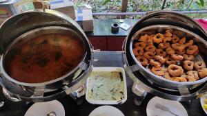 two pots of food on a stove with food at Cocorico Beach Resort in Dapoli