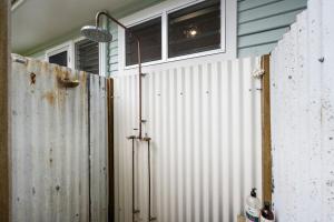 a metal fence in front of a house at Sea Dip at Iluka in Iluka +13 photos
