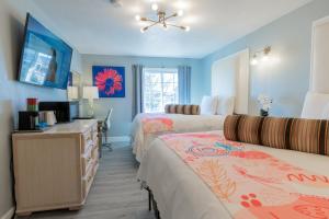 a hotel room with two beds and a television at Dragonfly Inn & Suites in Hastings +121 photos