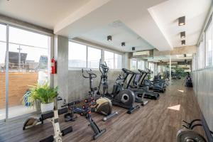 a gym with a bunch of treadmills and ellipticals at Patong Signature Boutique Hotel in Patong Beach