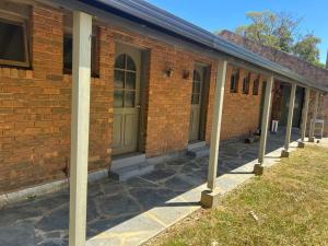 a brick building with columns in front of it at Harmonious One Bedroom Cabin in Wallan