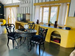 a dining room with a table and a fireplace at Casa Anjuna in Anjuna