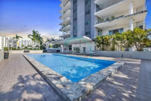 a swimming pool in front of a building at ZEN PINNACLE PENTHOUSE Darwin's Exclusive Zen Retreat in Darwin City in Darwin
