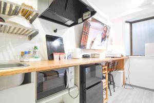Kuchyň nebo kuchyňský kout v ubytování Comfy Stay Sakuramachi