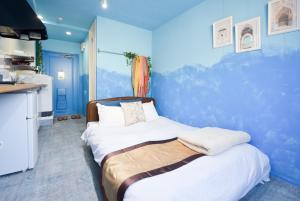 Postel nebo postele na pokoji v ubytování Comfy Stay Sakuramachi