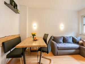 a living room with a table and a couch at Mountain Idyll by the River High-End Apartment in the Ötztal Valley 