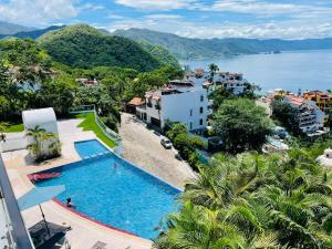 a swimming pool with a view of the water at Conchas chinas sunset view in Puerto Vallarta
