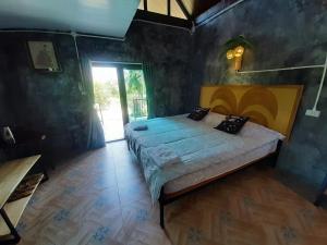 a bedroom with a large bed in a room at Parichat house ไร่ปาริชาติ in Ban Khanong Phra Tai +131 photos