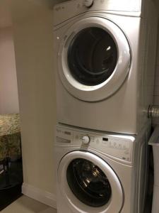 a washing machine and a washer in a kitchen at Lovely Downtown House +2 parking in Toronto