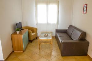 a living room with a couch and a table at Case Gialle in San Teodoro