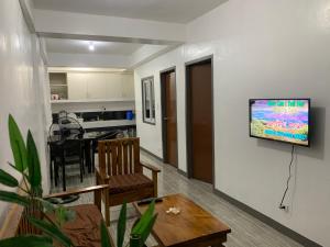 a living room with a television on a wall at Romblon Transient House in Romblon