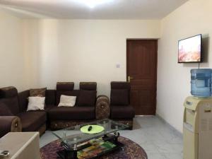 a living room with a couch and a table at Zanale Stays Furnished Apartment? in Nairobi