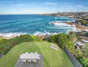 a view of the ocean from the backyard of a house at Oceanfront Tamarama Apartment: Best View in Sydney in Sydney