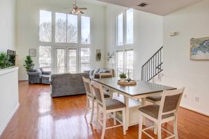 a dining room and living room with a table and chairs at Downtown Houston Townhome with City Views! in Houston