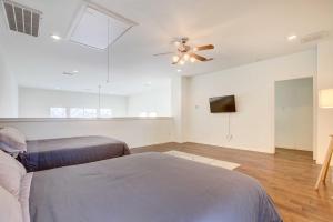 a living room with a couch and a ceiling fan at Downtown Houston Townhome with City Views! in Houston