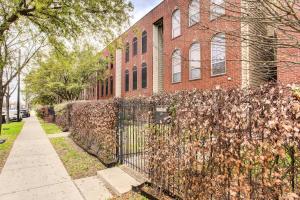 a fence in front of a brick building at Downtown Houston Townhome with City Views! in Houston