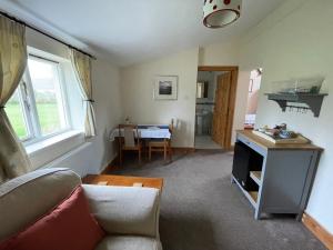 a living room with a couch and a table at The Waterings in St. Davids