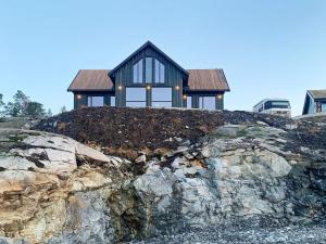 a house sitting on top of a rock at Holiday home Drangedal in Drangedal