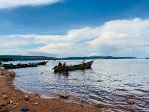 a group of people in boats on a body of water at Home On The Nile water front Cottage in Jinja