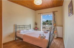 a bedroom with a bed and a window and a table at oli terra in Lefkada