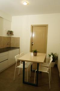 a kitchen with a table and chairs in a room at DayOne Suites Kuvempu in Bangalore