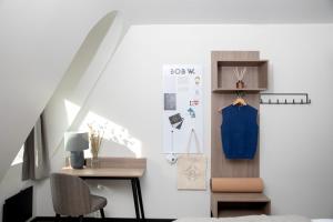 a room with a bed and a table and a chair at Bob W Oslo Sentralen in Oslo