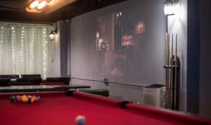 a billiard room with a red pool table at One Way Guesthouse Busan in Busan