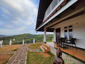 a porch of a house with a statue in front of it at The Highlander in Vagamon