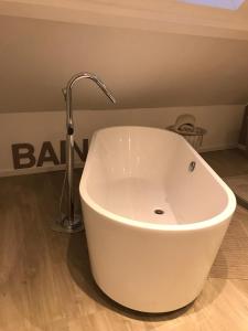 lavabo blanco con grifo en el baño en Gîte Durbuy, en Durbuy