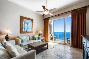 a living room with a couch and a ceiling fan at Caribbean Resort 1802 in Navarre