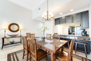 a kitchen and dining room with a table and chairs at Caribbean Resort 1802 in Navarre