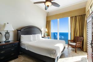 a bedroom with a bed and a large window with the ocean at Caribbean Resort 1802 in Navarre