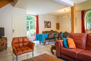 a living room with a couch and a table at Domaine De La Tour in Saint-Pierre-Canivet