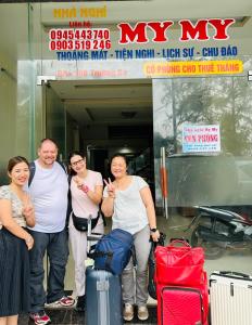 a group of people standing in front of a truck with luggage at MyMy Motel in Da Nang