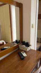 a counter with two remote controls and a mirror at Hotel Atlanta in Patra