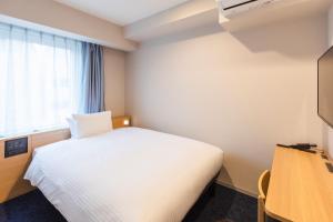 Ένα ή περισσότερα κρεβάτια σε δωμάτιο στο Sotetsu Fresa Inn Yodoyabashi