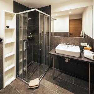 a bathroom with a sink and a shower at Apart Piz Lad in Nauders