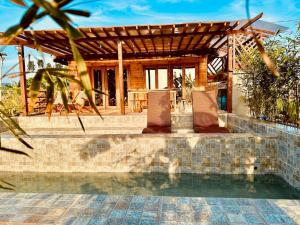 a house with a swimming pool and a pavilion at Rancho Oco Pinewood Villa with Swimming Pool in Nasugbu