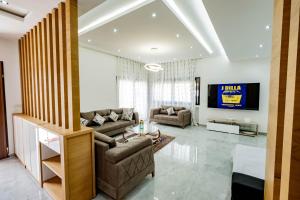 a living room with two couches and a tv at Villetta di lusso in Tunisia in Tunis