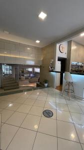 a large living room with a clock on the wall at Hotel Atlanta in Patra