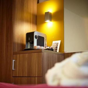 a hotel room with a tv on top of a cabinet at Holiday Inn Brussels Schuman, an IHG Hotel in Brussels