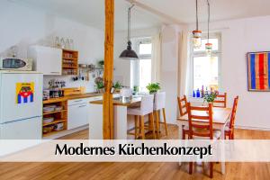 a kitchen and dining room with a white refrigerator at Modernes Altbau-Loft "HomeSweetHome" mit Kingsize Bett, Smart-TV, etc in Erfurt