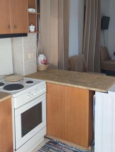 a kitchen with a stove and a counter top at Panorama Appartment in Agia Marina